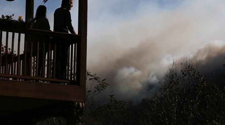 November 16, 2016, Tate City: Eric and Vebbra Willey watch from their porch as the Rock Mountain Fire approaches closer to their home on Wednesday, Nov. 16, 2016, in Tate City. Residents are under a pre-evacuation order as firefighters work to keep the fire away from homes. Curtis Compton/ccompton@ajc.com