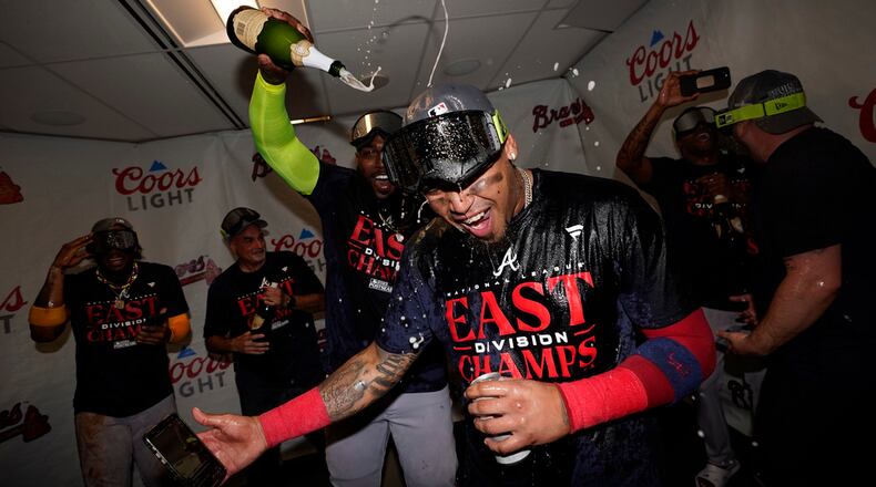 Atlanta Braves' Orlando Arcia celebrates with teammates after the Braves clinched their sixth consecutive NL East title by defeating the Philadelphia Phillies in a baseball game, Wednesday, Sept. 13, 2023, in Philadelphia. (AP Photo/Matt Slocum)
