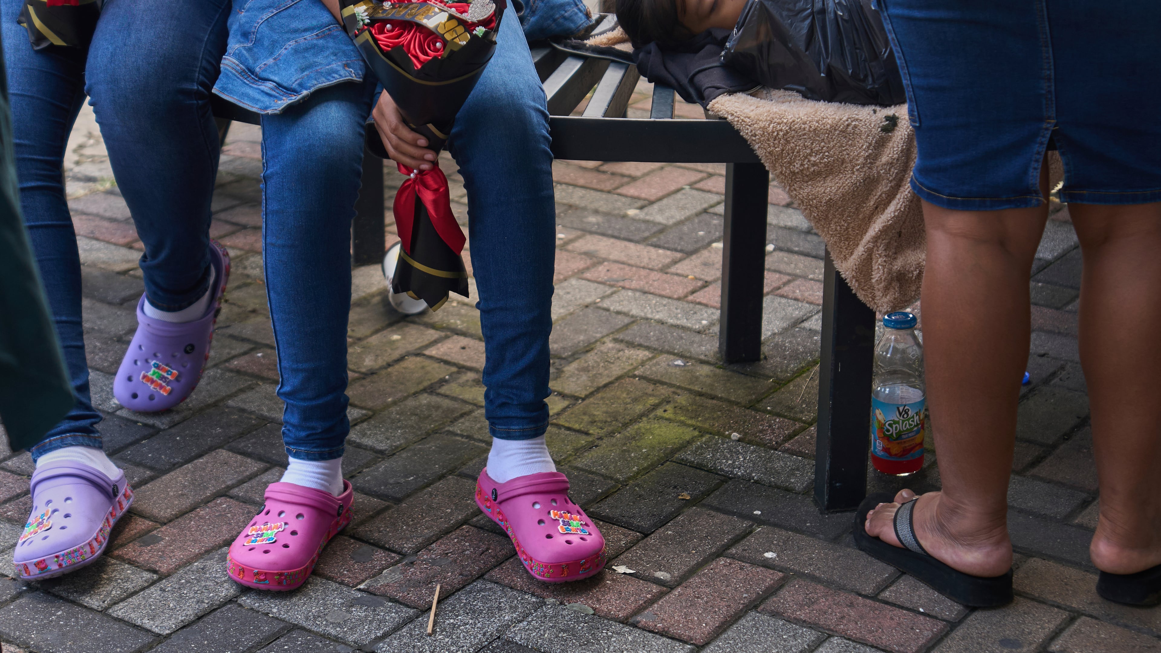 People wait for loved ones from Guatemala deported from the United States outside La Aurora International Airport, in Guatemala City, Sunday, Aug. 31, 2025. (AP Photo/Moises Castillo)