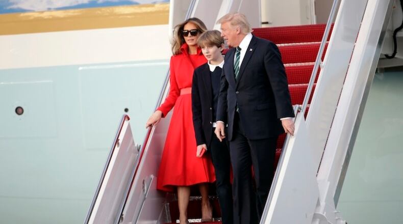 President Donald Trump walks from Air Force One with First Lady Melania and son Barron after arriving at the Palm Beach International Airport, Friday, March 17, 2017, in West Palm Beach, Fla. Trump is spending the weekend at his Mar-a-Lago Estate in Palm Beach. (AP Photo/Lynne Sladky)