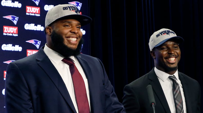 New England Patriots first-round NFL draft picks, offensive lineman Isaiah Wynn, left, and running back Sony Michel, both out of the University of Georgia, laugh during a media availability, Friday, April 27, 2018, in Foxborough, Mass. (AP Photo/Bill Sikes)