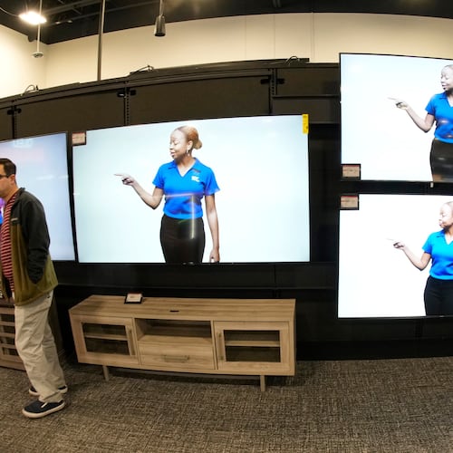 FILE - A customer turns away after looking at big-screen televisions on display in a Best Buy store, Nov. 21, 2023, in southeast Denver. (AP Photo/David Zalubowski, file)