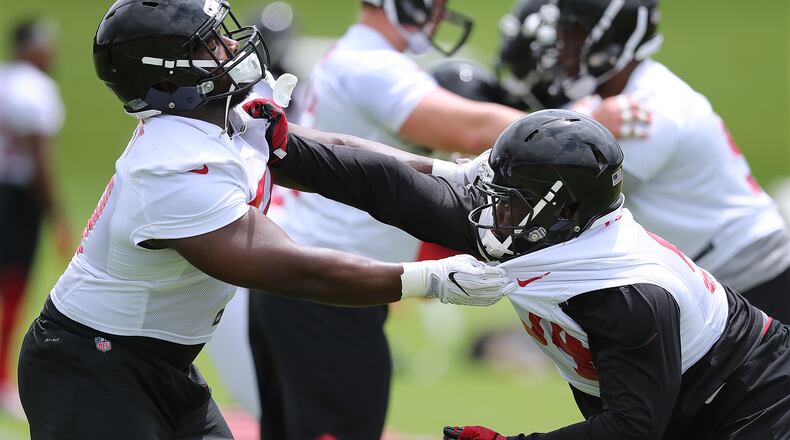 Atlanta Falcons defensive tackles Grady Jarrett (left) and Deadrin Senat get in some line work during organized team activity on Wednesday, May 30, 2018, in Flowery Branch.  Curtis Compton/ccompton@ajc.com