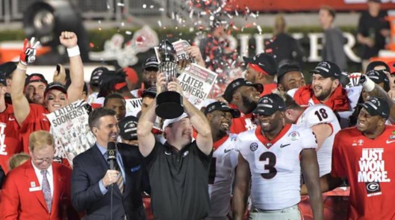 Georgia head coach Kirby Smart lifts the Rose Bowl trophy in triumph after Monday's historic win.