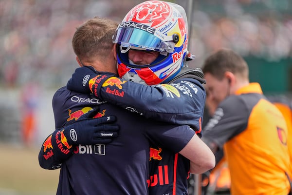 Red Bull driver Max Verstappen of the Netherlands hugs a team memebr after taking the pole position during the qualifying for the British Formula One Grand Prix in Silverstone, England, Saturday, July 5, 2025. (AP Photo/Darko Bandic)