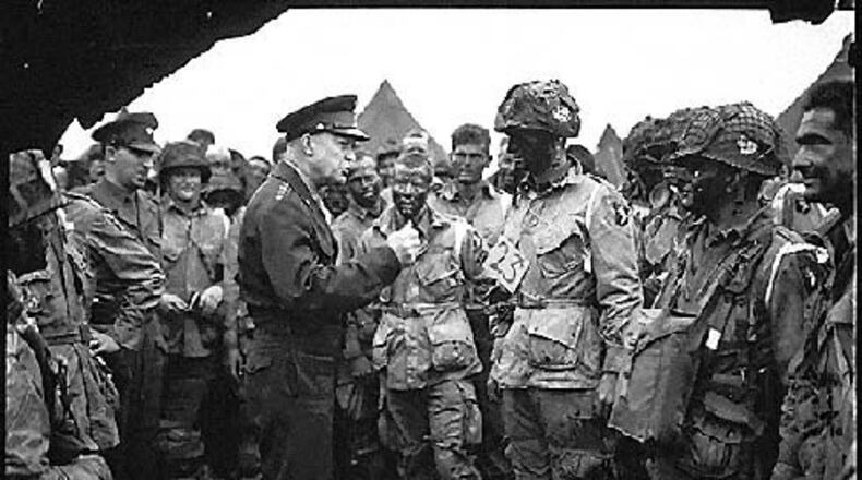Supreme Allied Commander U.S. Army Gen. Dwight D. Eisenhower speaks with 101st Airborne Division paratroopers before they board airplanes and gliders to take part in a parachute assault into Normandy as part of the Allied Invasion of Europe, D-Day, June 6, 1944.