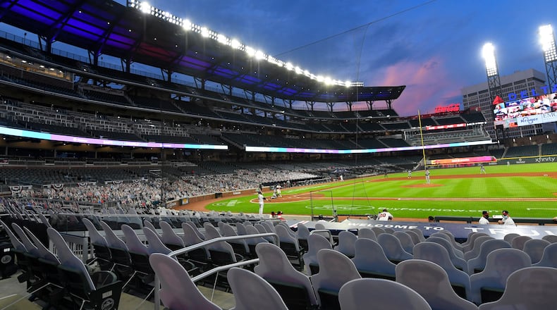 Cardboard cutouts replaced fans at Truist Park this year. The absence of fans meant a precipitous drop in the Braves' revenue.  AP Photo/John Amis)