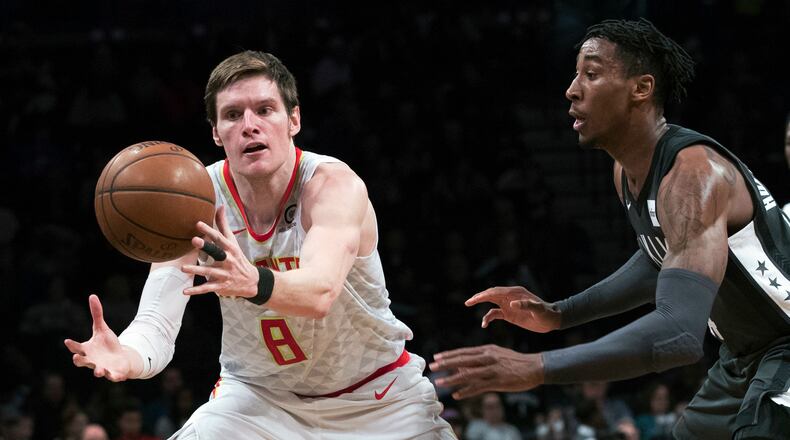 Brooklyn Nets forward Rondae Hollis-Jefferson, right, guards Atlanta Hawks forward Luke Babbitt (8) during the second half of an NBA basketball game, Saturday, Dec. 2, 2017, in New York. The Hawks won 114-102. (AP Photo/Mary Altaffer)