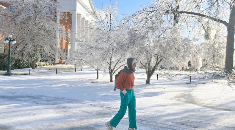 A woman walks across the campus of the University of Mississippi in Oxford, Miss. on Monday, Jan. 26, 2026, following a weekend ice storm. (AP Photo/Bruce Newman)