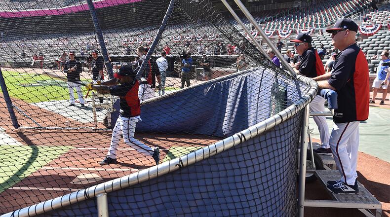 Braves manager Brian Snitker (right) and hitting coach Kevin Seitzer watch batting practice before the start game Friday, Oct. 4, 2019, at SunTrust Park (no Truist Park) in Atlanta.