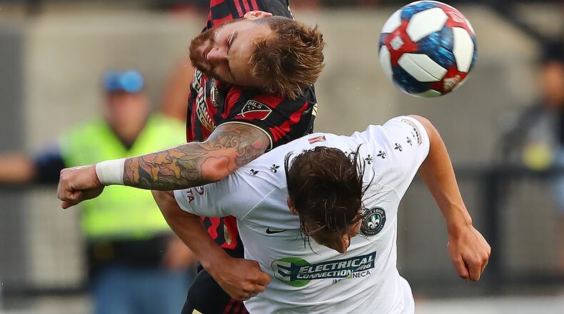 July 10, 2019 Kennesaw: Atlanta United defender Leandro Gonzalez Pirez collides with St. Louis forward Russell Cicerone as they battle for the ball in a U.S. Open Cup quarterfinals soccer match on Wednesday, July 10, 2019, in Kennesaw.  Curtis Compton/ccompton@ajc.com