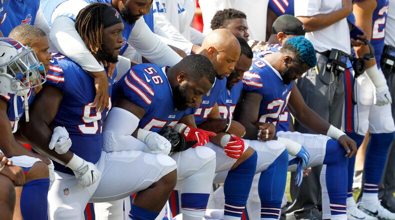 Buffalo Bills players kneel during the national anthem prior to an NFL football game against the Denver Broncos, Sunday, Sept. 24, 2017, in Orchard Park, N.Y. (AP Photo/Jeffrey T. Barnes)