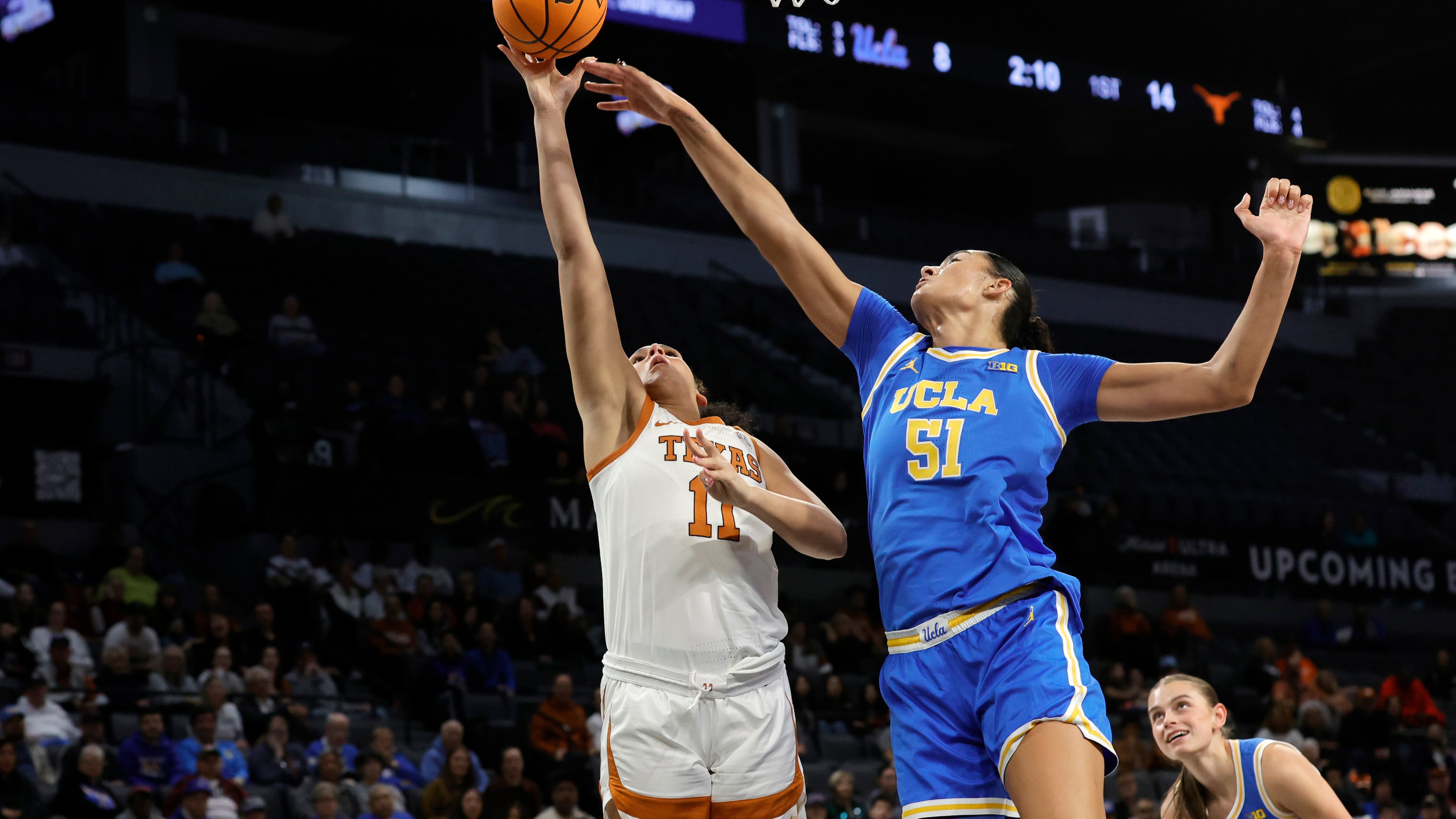 Texas forward Justice Carlton (11) shoots a layup against UCLA center Lauren Betts (51) during the first half of an NCAA college basketball game in the Players Era tournament Wednesday, Nov. 26, 2025, in Las Vegas. (AP Photo/Steve Marcus)