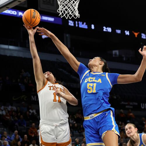 Texas forward Justice Carlton (11) shoots a layup against UCLA center Lauren Betts (51) during the first half of an NCAA college basketball game in the Players Era tournament Wednesday, Nov. 26, 2025, in Las Vegas. (AP Photo/Steve Marcus)