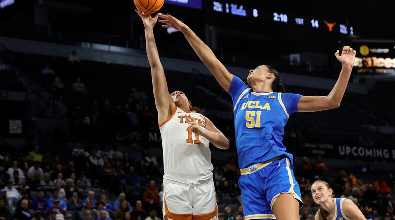 Texas forward Justice Carlton (11) shoots a layup against UCLA center Lauren Betts (51) during the first half of an NCAA college basketball game in the Players Era tournament Wednesday, Nov. 26, 2025, in Las Vegas. (AP Photo/Steve Marcus)