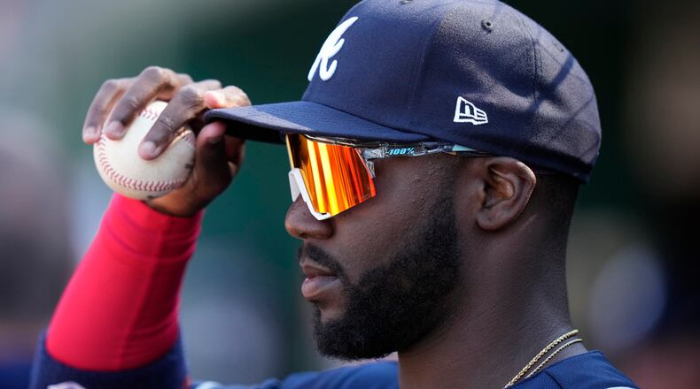 Atlanta Braves' Michael Harris II adjusts his hat while standing in the dugout during the eighth inning of an opening day baseball game against the Washington Nationals at Nationals Park, Thursday, March 30, 2023, in Washington. (AP Photo/Alex Brandon)