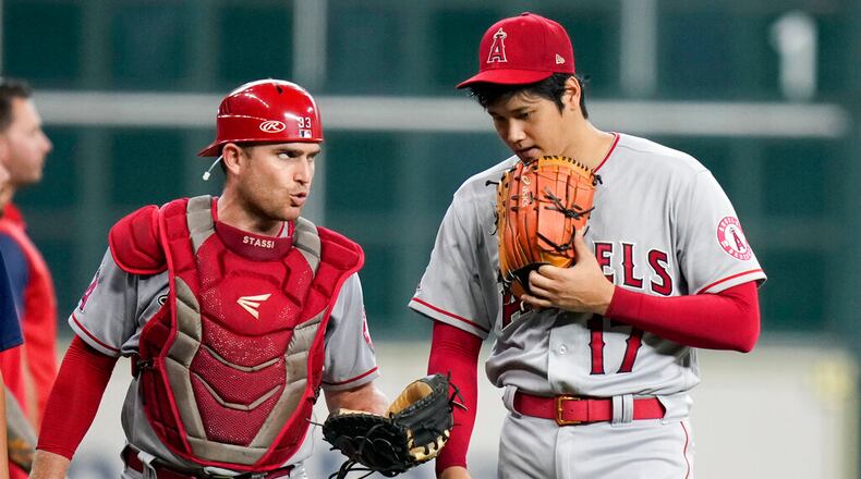 Los Angeles Angels starting pitcher Shohei Ohtani, right, talks with catcher Max Stassi before the team's baseball game against the Houston Astros, Saturday, Sept. 10, 2022, in Houston. (AP Photo/Eric Christian Smith)