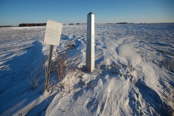FILE - A border marker, between the United States and Canada is shown just outside of Emerson, Manitoba, on Thursday, Jan. 20, 2022. (John Woods/The Canadian Press via AP, File)