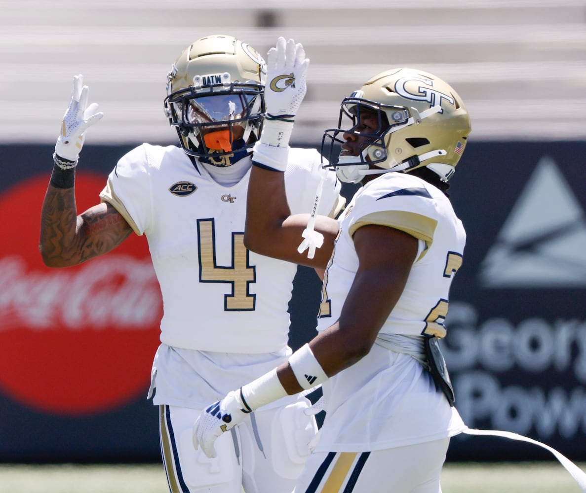Defenders Daiquan White (4) and Elgin Sessions celebrate during Georgia Tech football team's annual White and Gold game in Atlanta on Saturday, April 12, 2025.  Players split into two teams — Team Swarm and Team Wreck ‘Em — with some players being asked to play on both squads.  (Bob Andres for the Atlanta Journal Constitution)