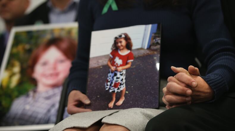 NEWTOWN, CT - JANUARY 14: Parents of Sandy Hook Elementary massacre victims hold hands during a press conference on the one month anniversary of the Newtown elementary school massacre on January 14, 2013 in Newtown, Connecticut. Eleven families of Sandy Hook massacre victims came to the event one month after the shooting to give their support to Sandy Hook Promise, a non-profit with the goal of preventing such tragedies in the future. (Photo by John Moore/Getty Images)
