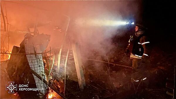 In this photo provided by the Ukrainian Emergency Service, firefighters put out the fire at the private houses following a Russian guided air bombs attack in Kherson, Ukraine, Saturday, March 15, 2025. (Ukrainian Emergency Service via AP)