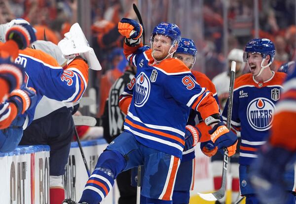 Edmonton Oilers' Corey Perry (90) and Ryan Nugent-Hopkins, back right, celebrate Perry's tying goal against the Florida Panthers during the third period in Game 2 of the NHL Stanley Cup Final, in Edmonton, on Friday, June 6, 2025. (Darryl Dyck/The Canadian Press via AP)