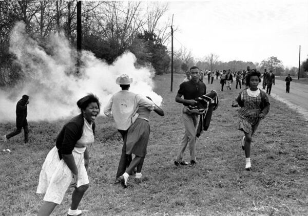 Demonstrators react to tear gas and smoke bombs set off to deter their voting-rights march in Camden, Alabama, in 1965. (AP photo.)