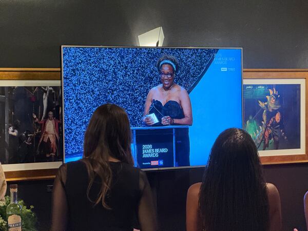 A view from the press room of chef Mashama Bailey presenting a beverage award at 2026 James Beard Awards. (Henri Hollis / AJC)