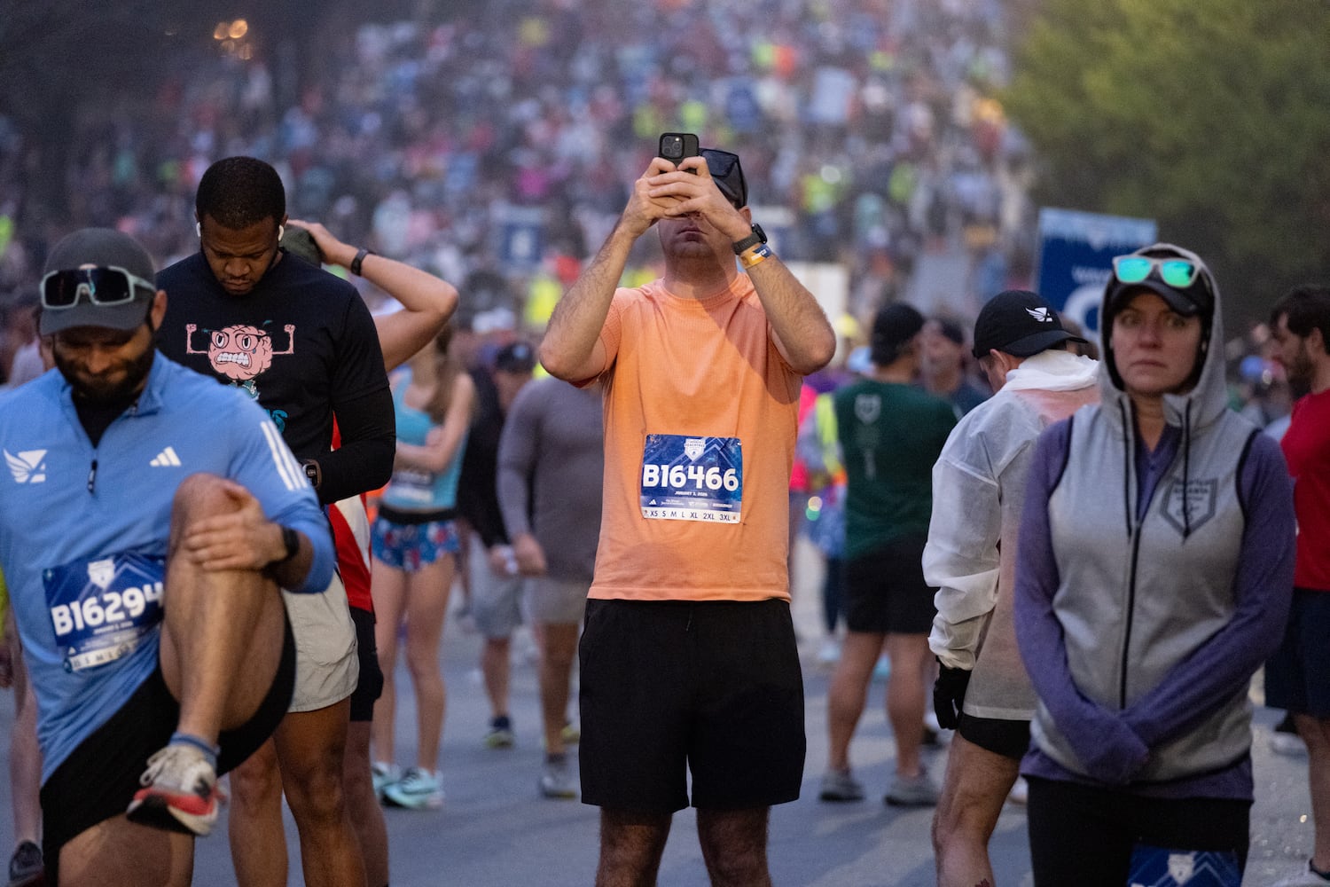 Thomas Puri takes a photo at the start line for the Polar Opposite Peachtree Road Race on Saturday, Jan. 3, 2026, in Atlanta. (Ben Gray for the AJC)