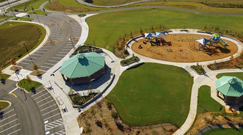 A new section of Alexander Park, 955 Scenic Highway/ Ga 124 in Lawrenceville, will open soon, featuring new playground equipment, a dog park, trails, additional parking, and restrooms. (Courtesy Gwinnett County)