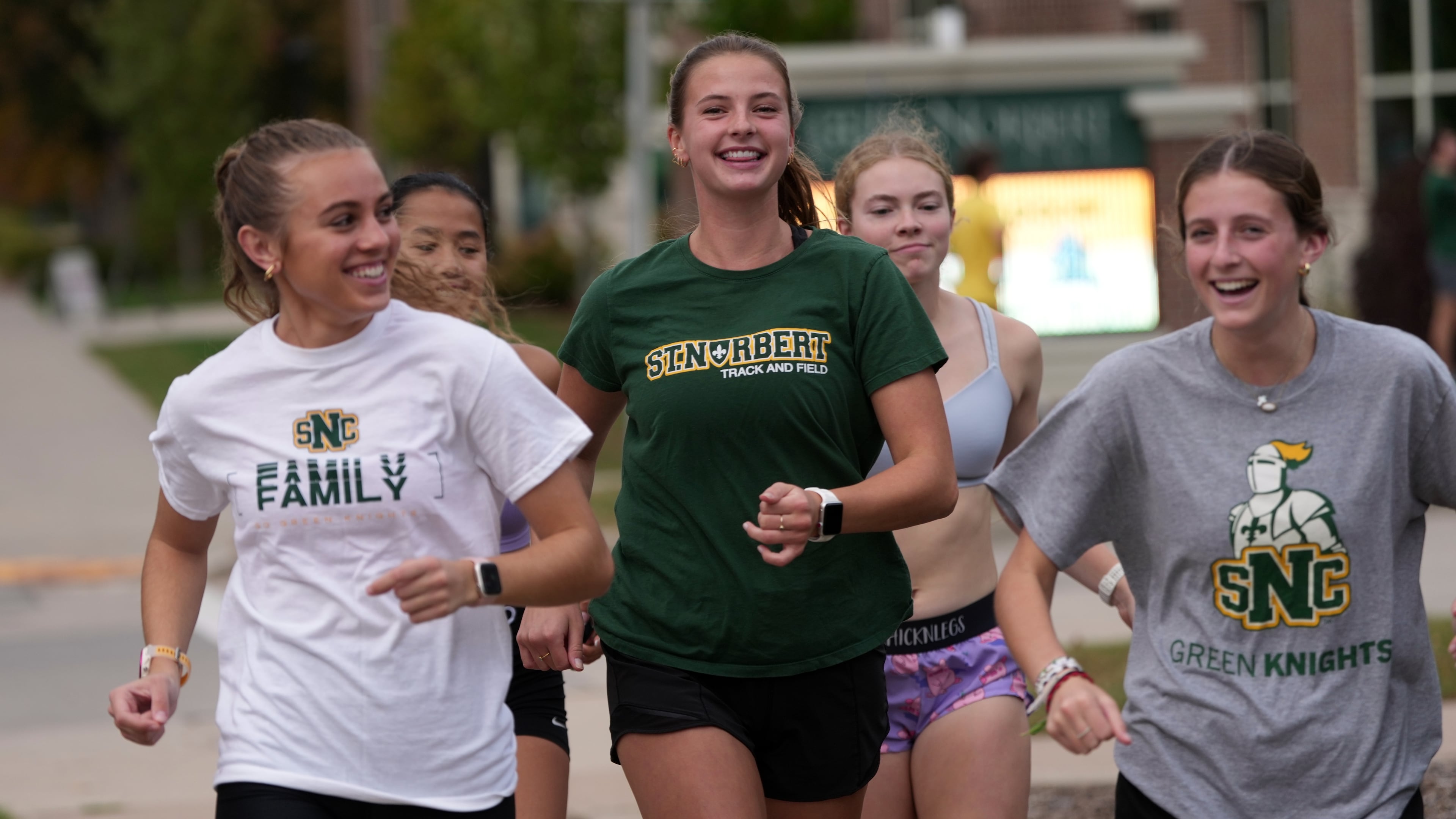 Cross country runner Madison DeCleene, center, runs with her St. Norbert College teammates, Friday, Oct. 17, 2025, in De Pere, Wis. (AP Photo/Morry Gash)