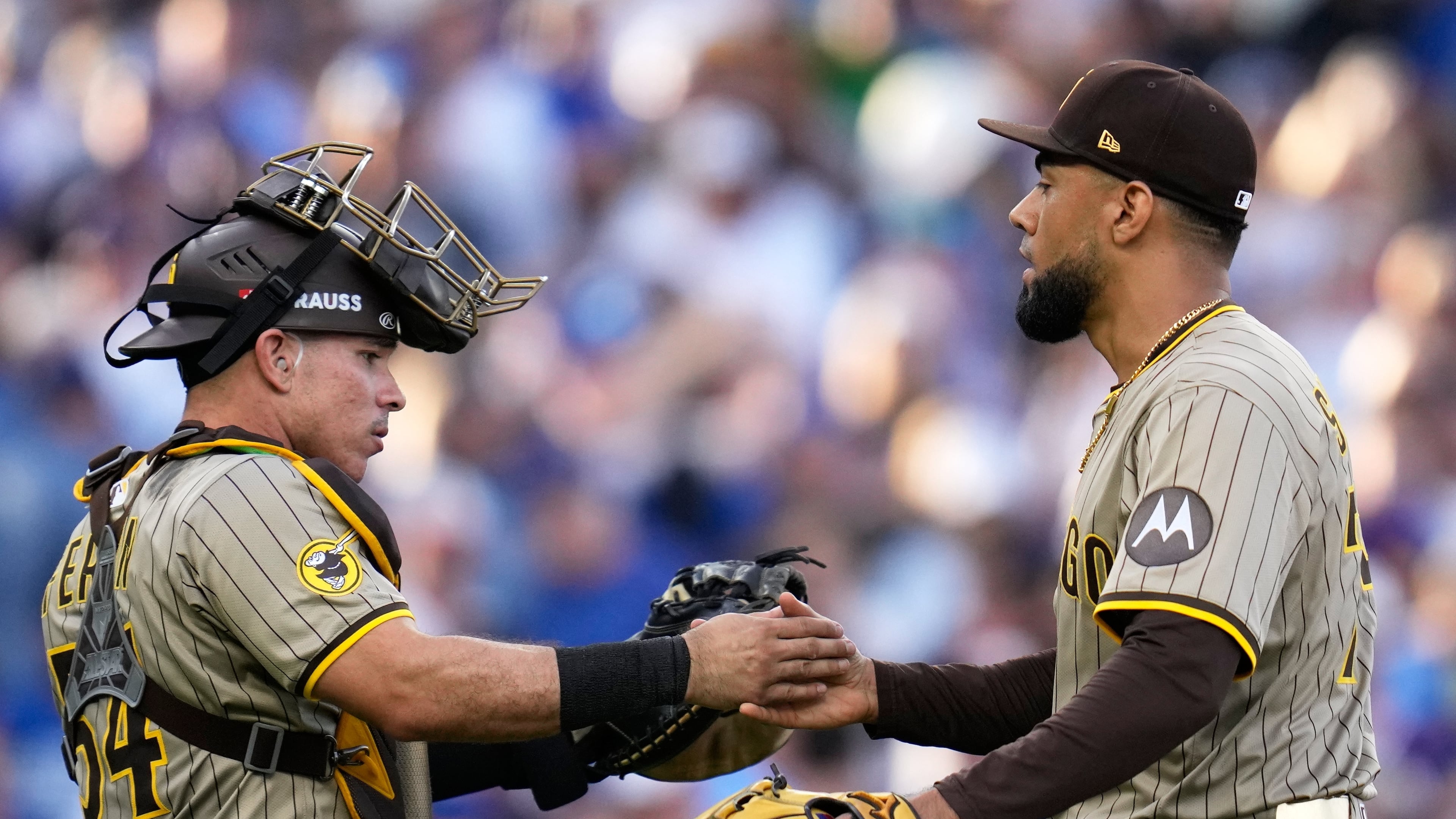 San Diego Padres' Robert Suarez and Freddy Fermin celebrate after Game 2 of a National League wild card baseball game against the Chicago Cubs Wednesday, Oct. 1, 2025, in Chicago. (AP Photo/Erin Hooley)