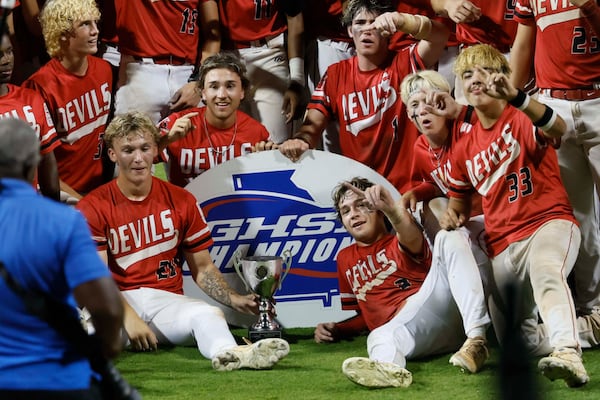 Loganville players pose with the trophy after winning 4-3 against Pope in Game 3 of the Class 5A GHSA baseball state championship series at Gwinnett Field on May 26, 2026, in Lawrenceville. (Miguel Martinez/AJC)