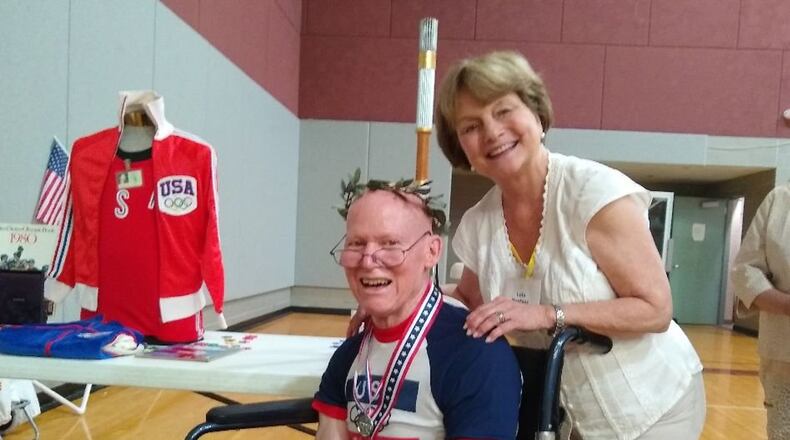 Respite Care Atlanta volunteer Lola Battle celebrates with Dick during an Olympics event held last year. Photo by Respite Care Atlanta