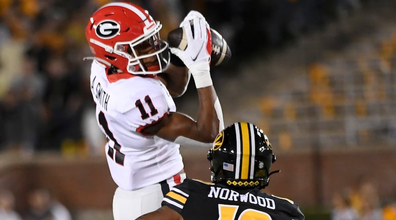 Georgia wide receiver Arian Smith (11) catches a pass as Missouri defensive back Dreyden Norwood (19) defends during the first half of an NCAA college football game Saturday, Oct. 1, 2022, in Columbia, Mo. (AP Photo/L.G. Patterson)