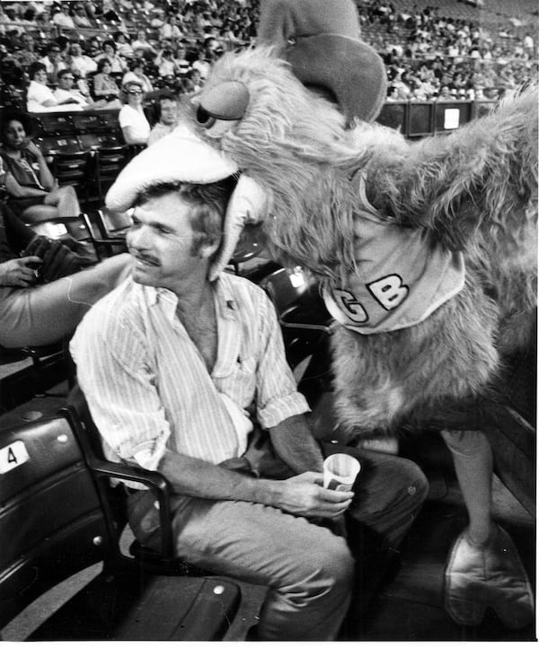 The San Diego chicken gets a mouthful of Braves owner Ted Turner on Sept. 5, 1978. (Jerome McClendon/AJC)