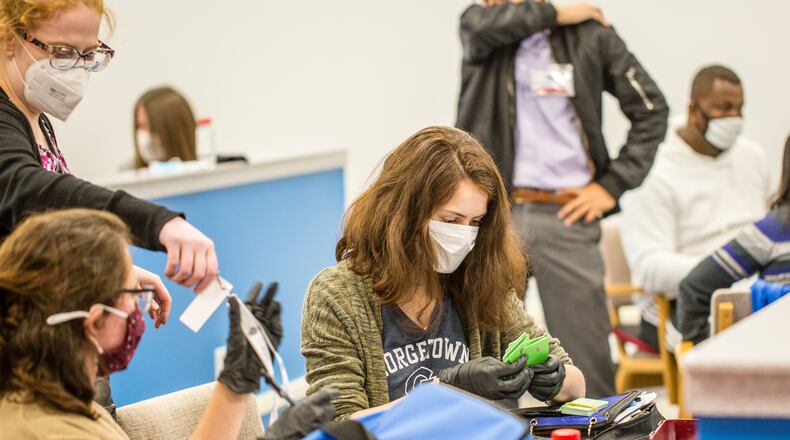 Gwinnett Voter Registrations and Elections office is busy with poll workers delivering ballots and data as well as counting absentee ballots and organize provisional ballots on Tuesday, Nov 3, 2020.  (Jenni Girtman for The Atlanta Journal-Constitution)