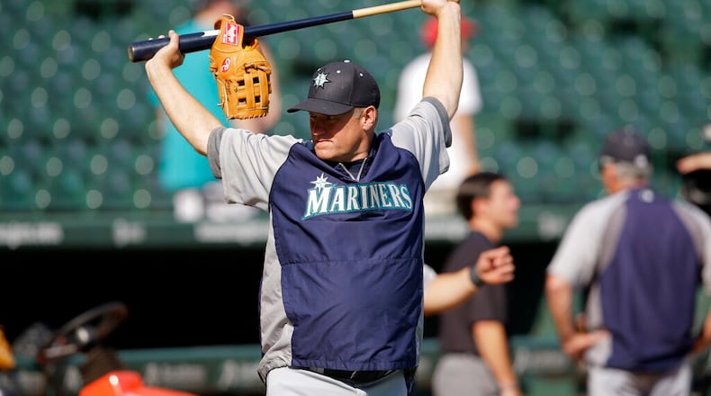 Seattle Mariners first base coach Mike Brumley (29) stretches as the team prepares to take batting practice before a baseball game against the Texas Rangers, Friday, Aug. 16, 2013, in Arlington, Texas. (AP Photo/Tony Gutierrez)