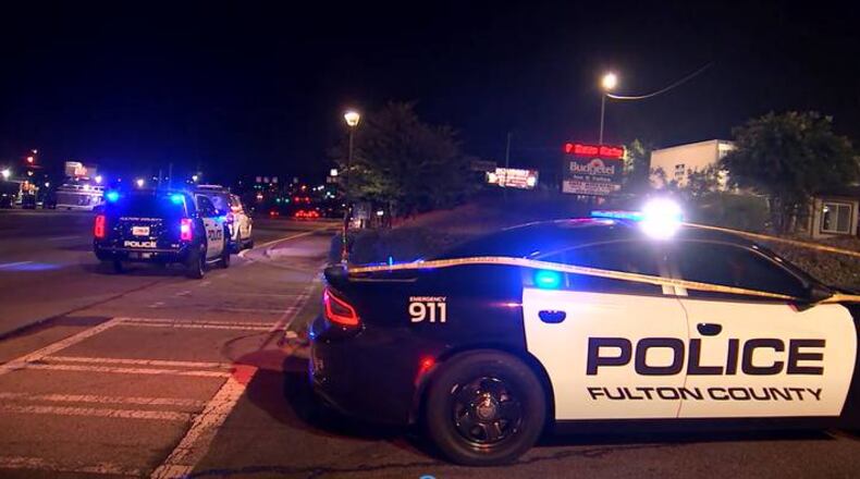 The woman was shot shortly after midnight outside a motel on Fulton Industrial Boulevard.