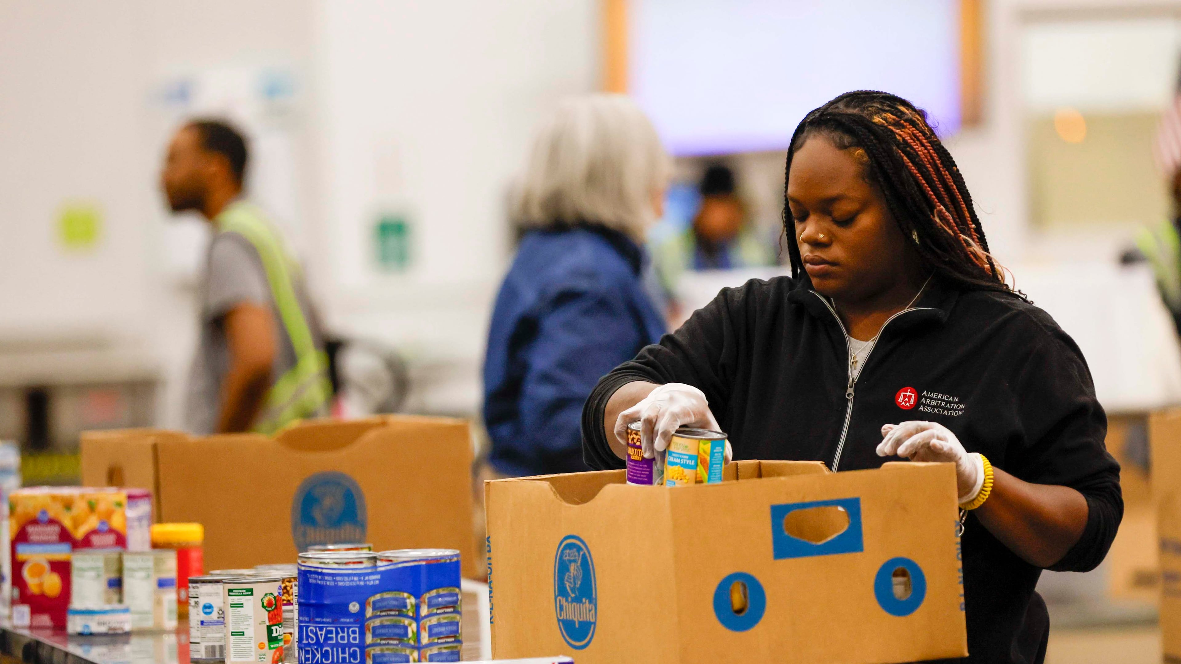 Volunteers are seen packing food at the Hunger Action Center at the Atlanta Community Food Bank Distribution Center on Wednesday, Oct. 29, 2025. State lawmakers are appealing to members of Congress to end the shutdown that has threatened food programs and left federal workers without pay. (Miguel Martinez/AJC)