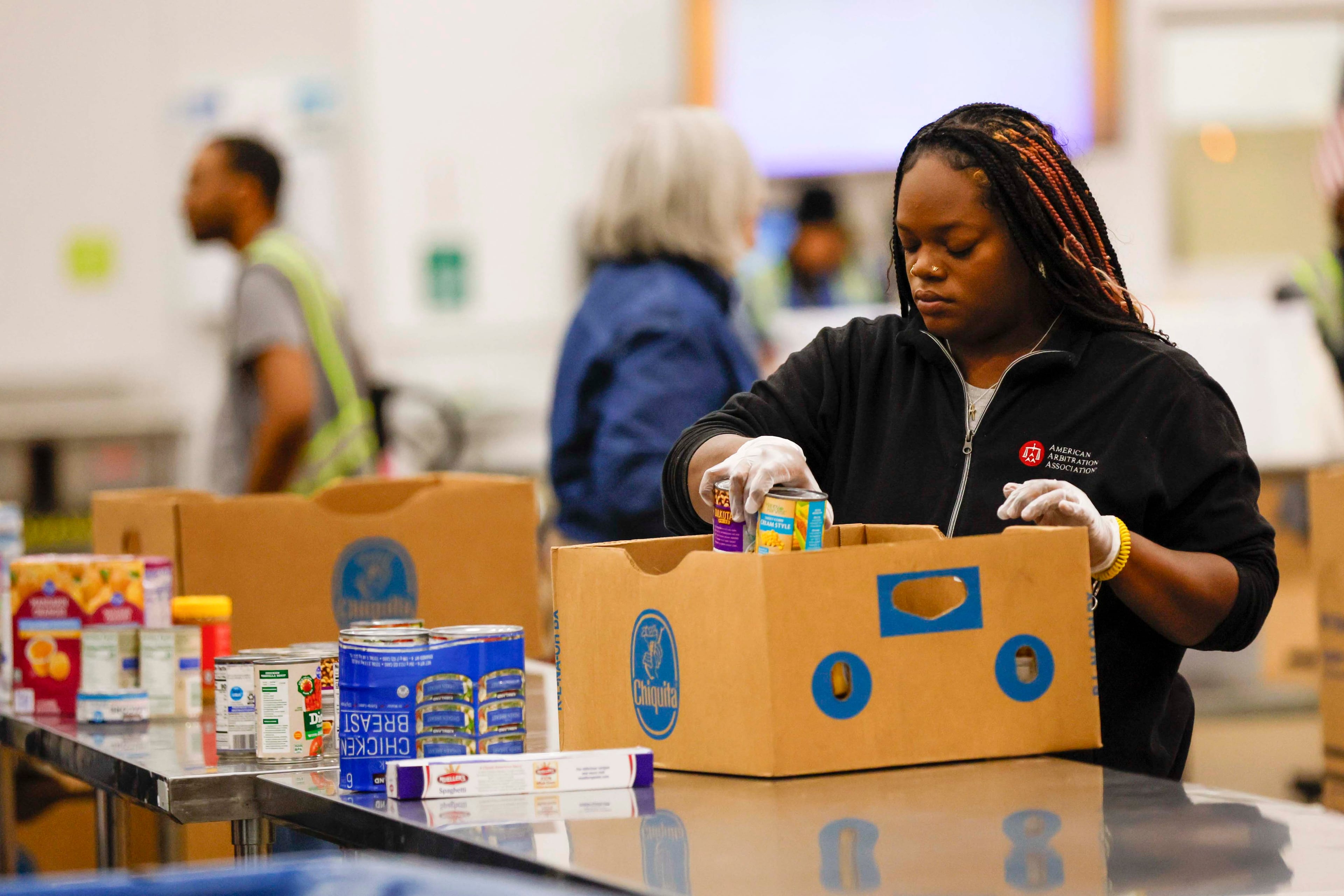 A volunteer packs food at the Atlanta Community Food Bank Distribution Center on Wednesday, October 29, 2025. (Miguel Martinez/AJC)
