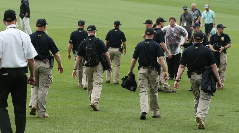 April 3, 2017, Augusta: GBI officers join security guards along the first fairway to help clear patrons from the golf course during a tornado watch suspending practice for the Masters at Augusta National Golf Club on Monday, April 3, 2017, in Augusta. Curtis Compton/ccompton@ajc.com