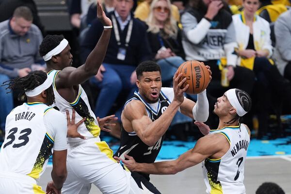 Milwaukee Bucks forward Giannis Antetokounmpo (34) is trapped by Indiana Pacers forward Pascal Siakam (43) and guard Andrew Nembhard (2) during the first half of a first-round NBA basketball playoff game in Indianapolis, Tuesday, April 22, 2025. (AP Photo/Michael Conroy)