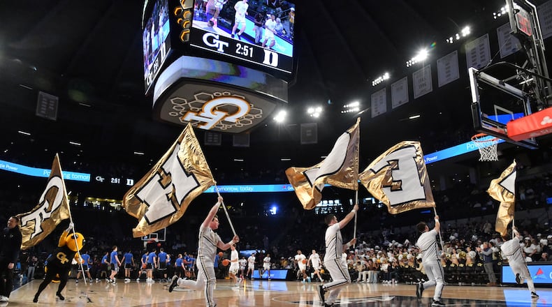 Members of Georgia Tech cheerleading team run onto the basketball court before their game against Duke at Georgia Tech’s McCamish Pavilion, Saturday, Jan. 28, 2023, in Atlanta. (Hyosub Shin / Hyosub.Shin@ajc.com)