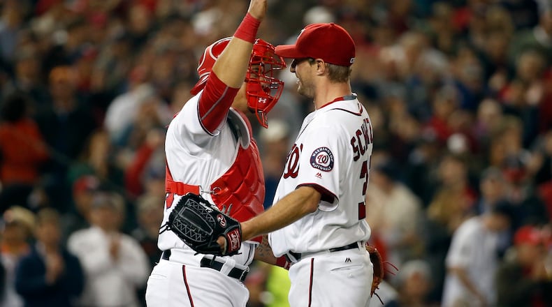 Washington Nationals starting pitcher Max Scherzer, right, celebrates with catcher Wilson Ramos after an interleague baseball game against the Detroit Tigers at Nationals Park, Wednesday, May 11, 2016, in Washington. Scherzer struck out 20 batters tying the major league nine-inning record. The Nationals won 3-2. (AP Photo/Alex Brandon)