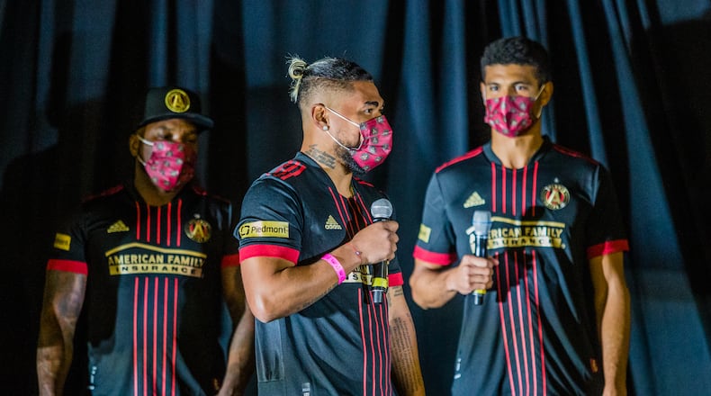 Atlanta United celebrates the beginning of their 5th season with Jay-Z, from left, Josef Martinez, and Miles Robinson unveiling the 2021 team uniforms Friday, Feb 26, 2021 during a drive-in at the Home Depot Backyard. (Jenni Girtman for The Atlanta Journal-Constitution)