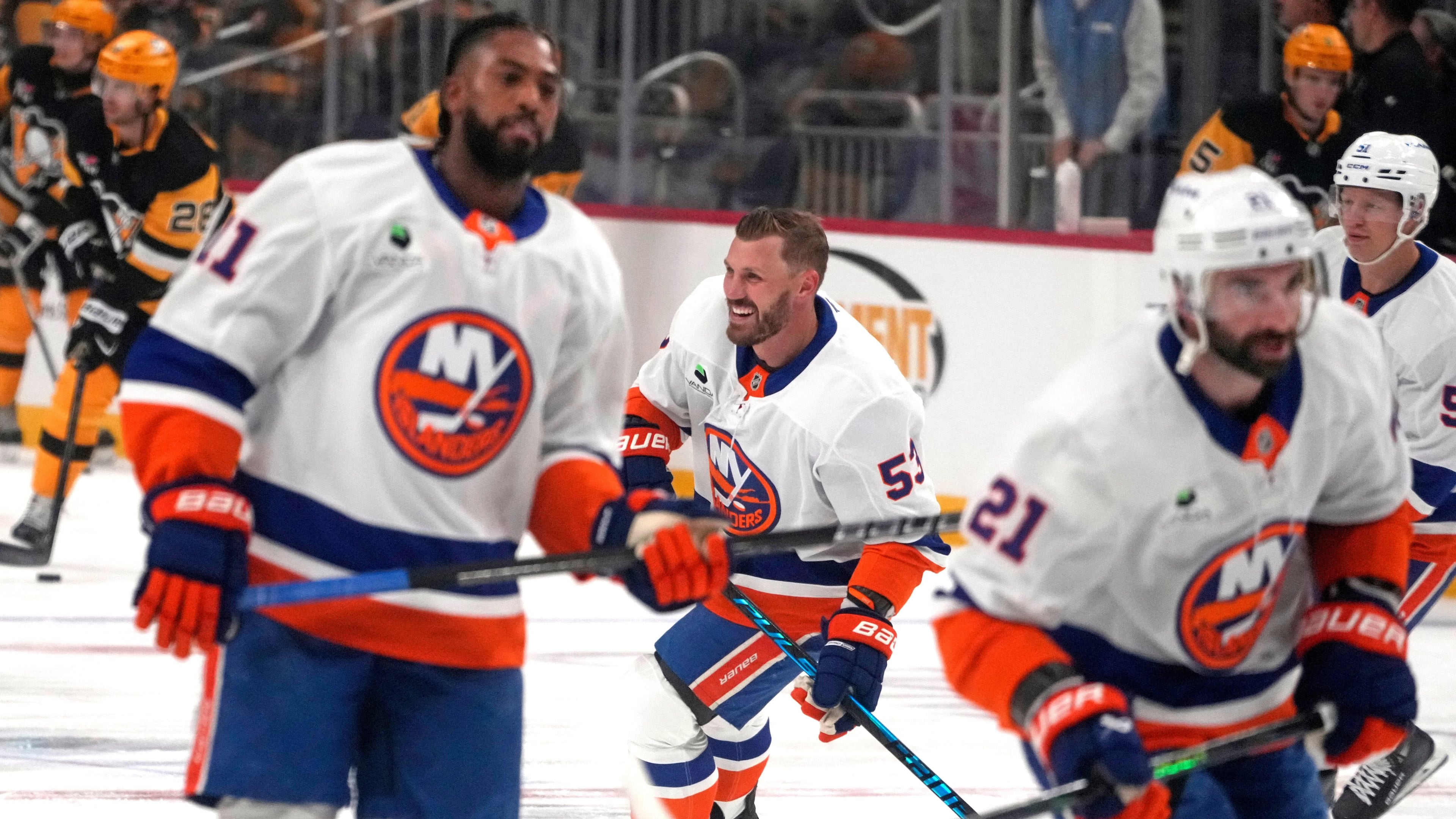New York Islanders' Casey Cizikas, center, Anthony Duclair, left, and Kyle Palmieri (21) skate during warm ups before an NHL hockey game against the Pittsburgh Penguins in Pittsburgh, Thursday, Oct. 9, 2025. (AP Photo/Gene J. Puskar)