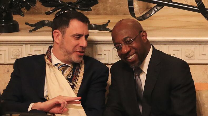 Chief Rabbi Peter S. Berg (left) and Rev. Raphael G. Warnock talk during the joint Martin Luther King Jr. Shabbat service on Friday, Jan. 17, 2020, at The Temple in Atlanta. Each year the congregations from The Temple and Ebenezer Baptist Church join for a Shabbat service to honor Martin Luther King Jr. as a symbol of the Black and Jewish alliance in Atlanta. (Christina Matacotta for the AJC)