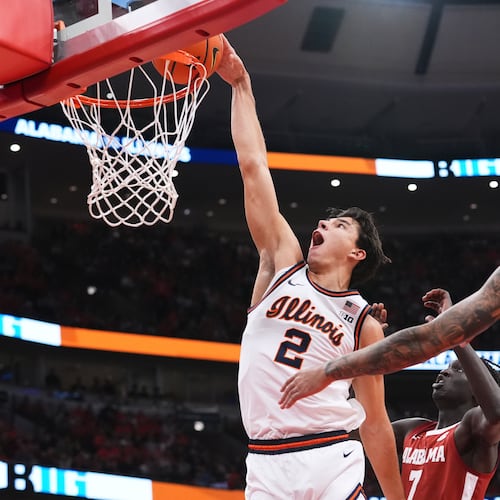 Illinois guard Andrej Stojakovic (2) dunks against Alabama during the first half of an NCAA college basketball game in Chicago, Wednesday, Nov. 19, 2025. (AP Photo/Nam Y. Huh)