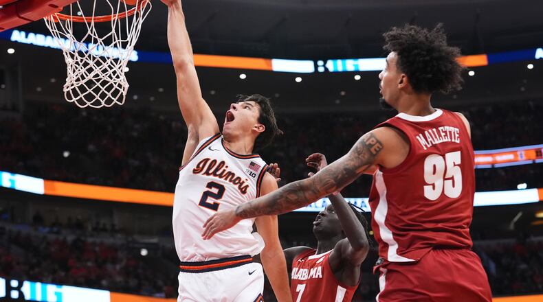 Illinois guard Andrej Stojakovic (2) dunks against Alabama during the first half of an NCAA college basketball game in Chicago, Wednesday, Nov. 19, 2025. (AP Photo/Nam Y. Huh)